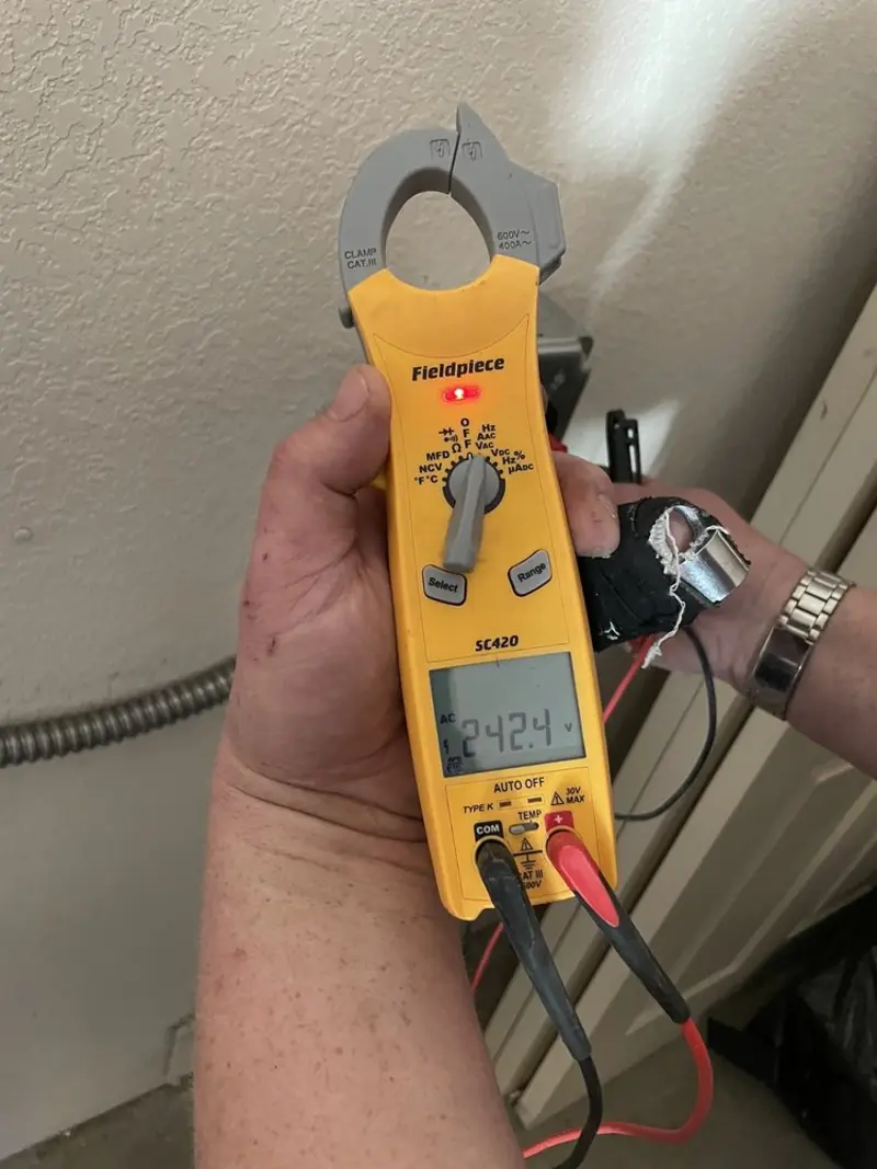 Voltage testing with clamp meter during Outlet Installation in Mayfair